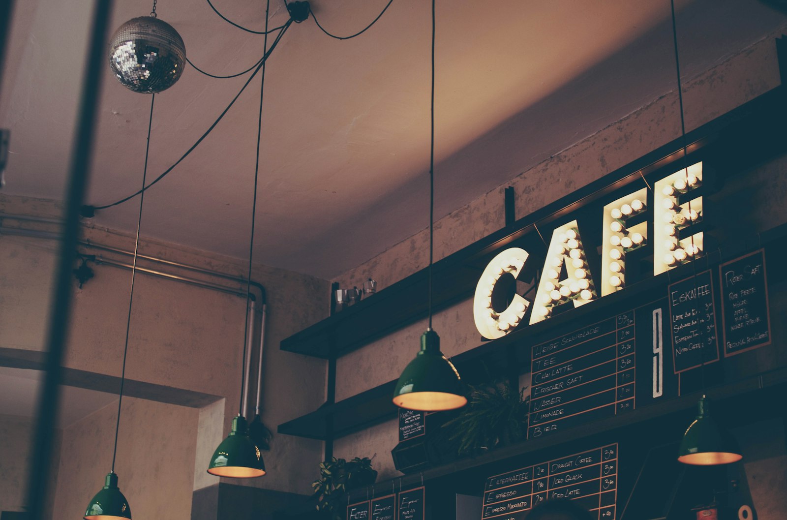 Warm café interior with a lit sign