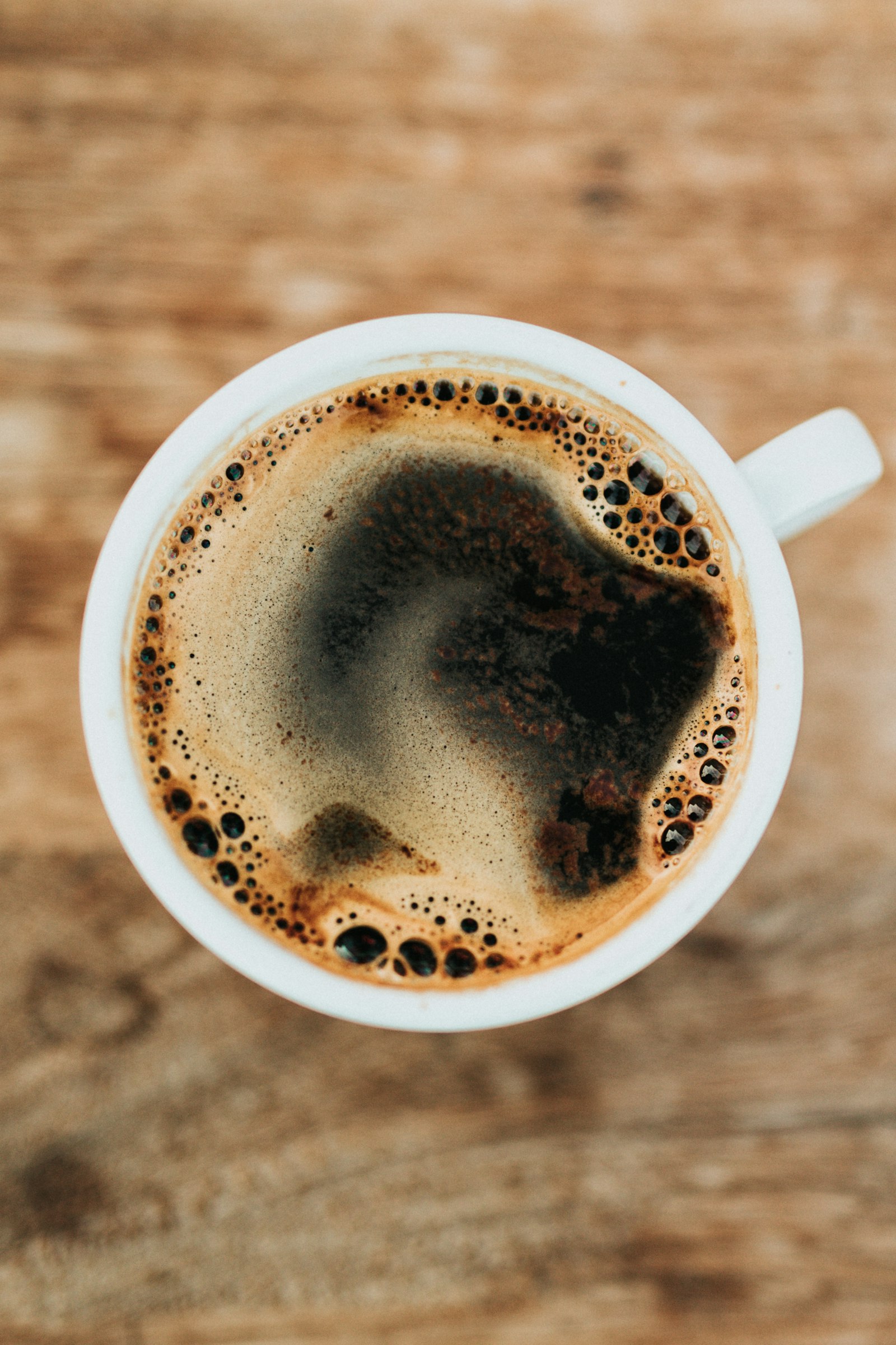 A dark, crema-topped cup of coffee
