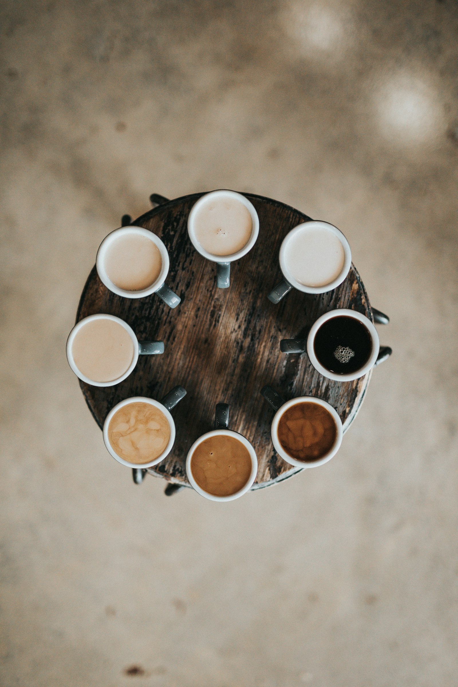 A flight of coffees on a round tray